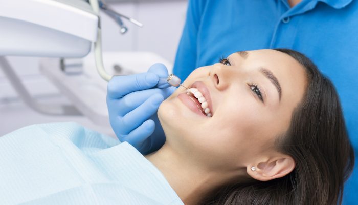 Dentist and patient in the dental office. Woman having teeth examined by dentists