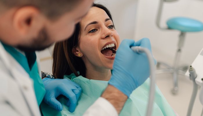 Dentist examining teeth of a female patient during a dental check-up