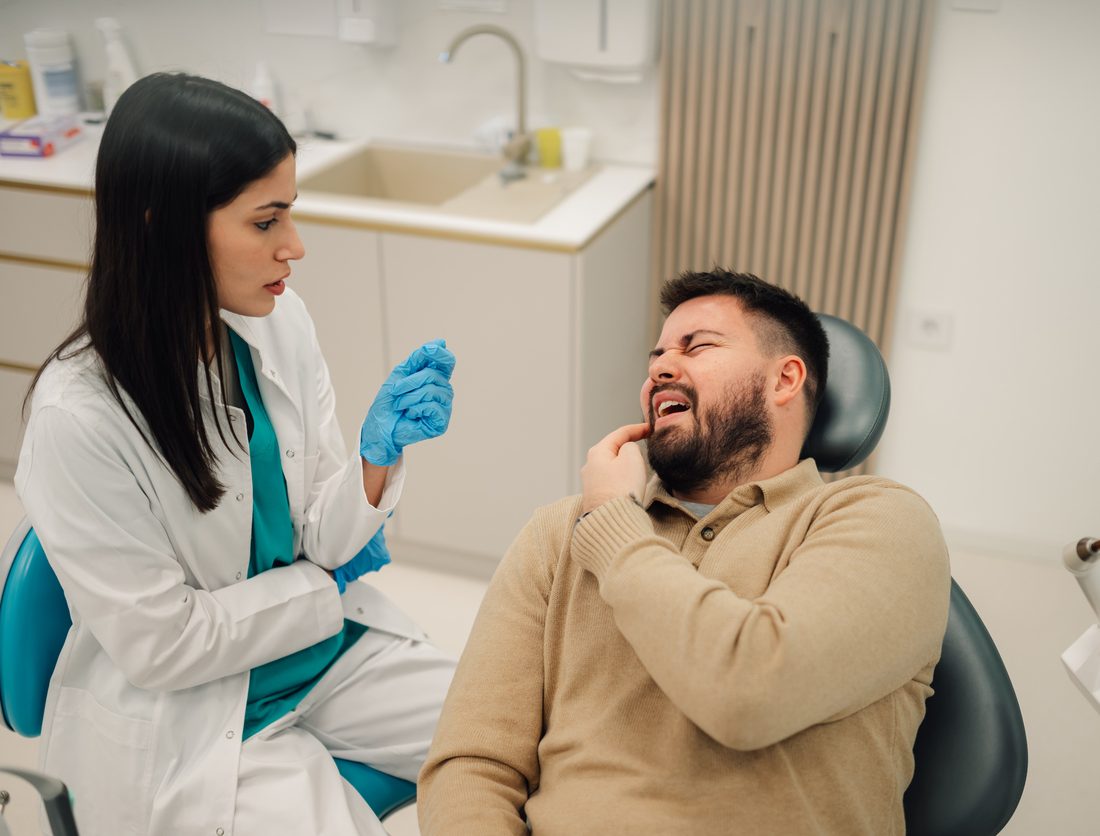 Patient complaining about toothache to dentist in dental clinic