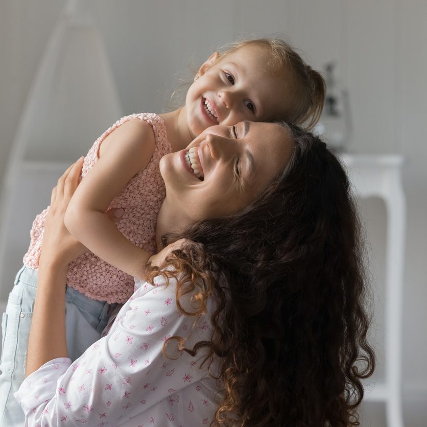 Adoption day. Portrait happy tender millennial foster mother cuddle hug hold in embraces with warmth care affection beloved preschool age girl little adopted daughter enjoy emotional bonding with kid